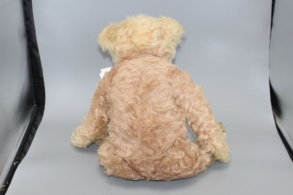 A c.1930s bear, possibly Farnell, 22in., faded pink mohair, original paw pads, good condition except faded head, 22in.